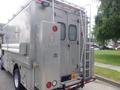 A 2007 Morgan Olson Workhorse W42 vehicle with a metallic exterior featuring a rear door, ladder, and side storage compartments