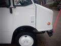 A white 2003 Freightliner MT45 Chassis with a rounded front hood and a single orange indicator light on the right side