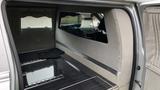 Interior view of a 2013 Lincoln MKT showing a spacious, polished area with dark flooring and plush light-colored upholstery designed for comfort and luxury