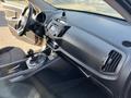 Interior view of a 2012 Kia Sportage showcasing the dashboard steering wheel and gear shifter