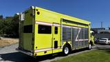 A yellow 1995 Freightliner FLL086 vehicle with a sliding side door and retroreflective accents designed for emergency or utility service