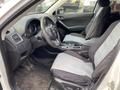 Interior view of a 2016 Mazda CX-5 featuring two cloth seats with a central console and steering wheel visible