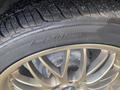 A close-up of a tire and wheel assembly with a shiny gold alloy rim and black tire tread visible showcasing the word ROTATION embossed on the tire sidewall
