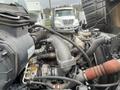 Close-up of the engine compartment of a 2008 Hino 268 showing various components including hoses and metal parts