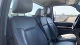 Interior view of a 2011 Ford F-450 SD with black leather seats and headrests visible in the foreground