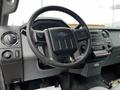 Interior view of a 2011 Ford F-250 SD focusing on the steering wheel dashboard controls and gear shifter