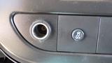 Close-up of a dashboard control panel featuring a power outlet and an OFF button in a 2012 GMC Savana