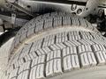 Close-up of a large tire from a 2010 Ford F-550 displaying deep tread patterns and a sturdy build designed for heavy-duty performance and traction