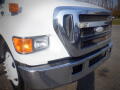 A 2007 Ford F-650 featuring a prominent chrome grille and front headlights with an orange turn signal.