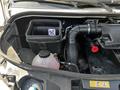 Engine compartment of a 2022 Mercedes-Benz Sprinter showing the air intake hose and a coolant reservoir