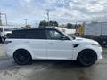 A 2020 Land Rover Range Rover Sport in white with black accents and black wheels viewed from the side