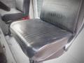 A black leather driver's seat from a 2003 Freightliner MT45 Chassis with horizontal stitching and a smooth surface