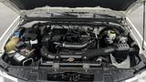 Engine compartment of a 2016 Nissan Frontier showcasing the engine components and design