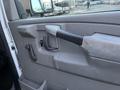 Interior door handle of a 2009 GMC Savana showing a gray plastic design with a lever and a small lock button