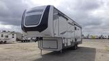 A 2021 Forest River Cedar Creek recreational vehicle with a sleek design and large front windshield