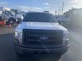 A white 2013 Ford F-150 pickup truck facing forward with a black front grill and a simple design