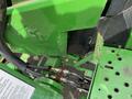 Close-up of the hydraulic connections and metal framework of a 2003 John Deere 790 tractor highlighting the green components and hoses