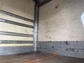 Interior of a 2008 Hino 268 truck showing a spacious cargo area with wooden flooring and metal strips along the walls