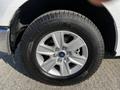 Close-up of a 2017 Ford F-150 aluminum alloy wheel and tire showing the Ford logo and detailed tread pattern
