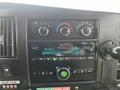 Dashboard of a 2017 Chevrolet Express featuring a radio display and control knobs for climate and audio settings