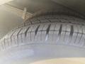 Close-up of the tread on two tires from a 2017 Chevrolet Express showing well-defined grooves and rubber texture