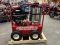 A red 2024 Magnum 4000 Hot Water Pressure Washer with a silver tank hose and a motor mounted on a wooden pallet