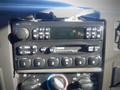 Dashboard controls of a 2006 Ford F-650 including radio dials and air conditioning knobs