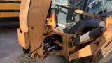 A 2015 Case 580 backhoe loader with a yellow and black color scheme featuring a front bucket and hydraulic arms