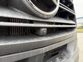 Close-up of a 2019 Mercedes-Benz Sprinter front grille featuring a camera mounted between the grille slats with droplets of water on the surface