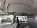 Interior view of a 2013 Toyota Sienna showing the ceiling and driver's seat with a black leather finish