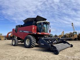 A red 2014 Versatile RT490 farming machine with a large black header attached in the front