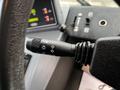 A close-up of a control lever from a 2007 Tennant Sentinel featuring various settings for lights and indicators