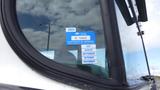 A blue certificate of approval sticker affixed to the window of a 2015 International PC105 displaying the year 2024 and months listed under the approval status