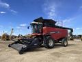 A red 2014 Versatile RT490 combine harvester with a black header attachment parked on a dirt surface