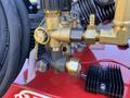 A close-up view of the brass fittings and hose connections on a 2024 Magnum 4000 Hot Water Pressure Washer showcasing valves and connectors