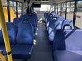 Interior of a 2017 Chevrolet Express with blue upholstered seats arranged in rows