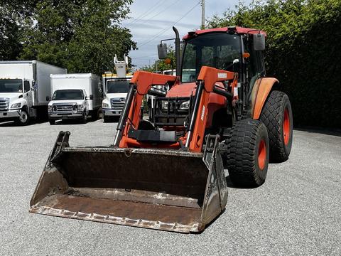 A 2011 Kubota M8540D tractor with large tires and a front loader attachment in the foreground