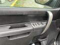 Interior view of a 2013 Chevrolet Silverado Hybrid showing the door handle and window control buttons