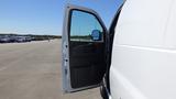 A white 2012 GMC Savana van with an open front door showcasing the interior space and driver’s seat