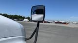 A 2019 International 4300 truck with a side mirror reflecting the driver's seat