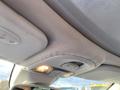 The interior ceiling of a 2015 Fiat 500L featuring light controls and fabric upholstery