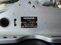 A label on a silver outboard motor displaying the Honda logo along with the model number BF20D and serial number BAMJ-1607816 made in Japan