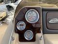 Dashboard of a 2013 Sylvan boat featuring analog gauges for speed and depth with a wooden panel finish