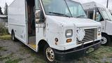 A white 2006 Ford Econoline cargo van with a flat front and a large side door parked in an outdoor area