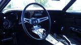 Interior view of a 1971 Chevrolet Corvette Stingray showcasing the steering wheel dashboard and gear shift