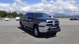 A 2014 RAM 3500 pickup truck in black with a silver grille and a front bull bar parked in a lot