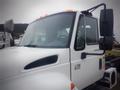 White 2006 International 4300 truck with a large front windshield and prominent side mirror