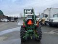 A 2003 John Deere 790 tractor viewed from the rear with large tires and a mounted option on the front