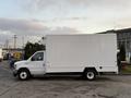 A white 2021 Ford Econoline with a boxy cargo area and standard wheels parked on a surface