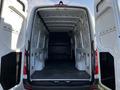 Interior view of a 2022 Mercedes-Benz Sprinter van showcasing the spacious cargo area with open rear doors and a clean floor